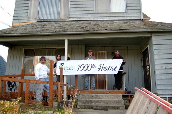 Cuba Johnson stands proudly on her porch with Rebuilding Together volunteers. (photo courtesy of Rebuilding Together)